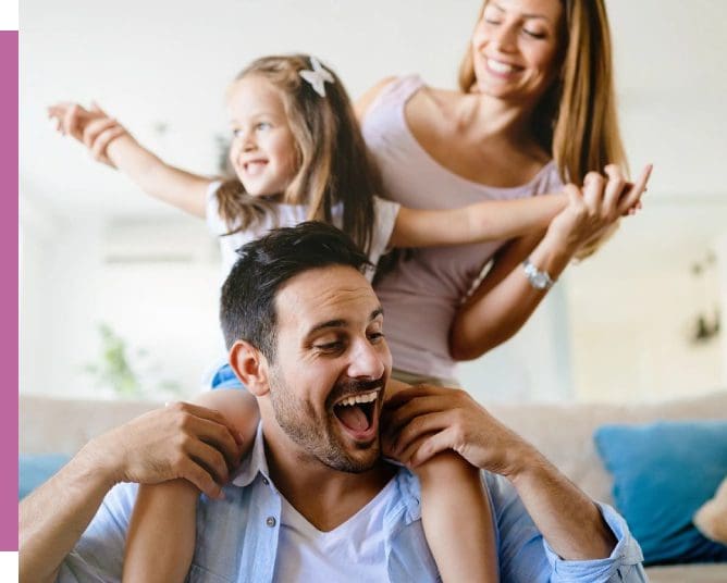 A man and woman are playing with their daughter.