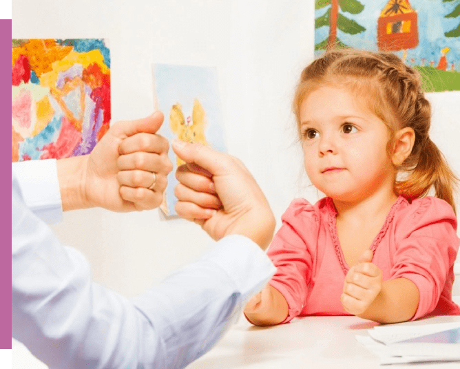 A child is holding up an animal card.